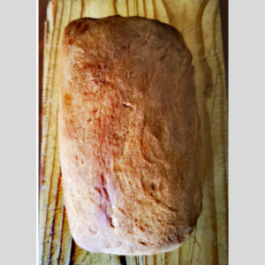 A peasant loaf on a wooden plank from HapnHop Padstal