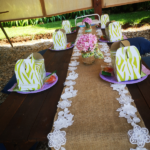 hessian overlay on picnic table with lime green party packs and hydrangea